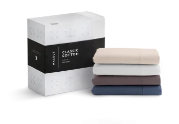 Malouf Classic Cotton Sheet Set packaging beside folded sheets in four colors